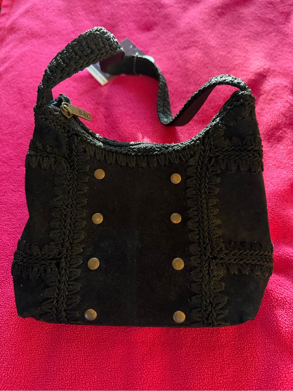 The Sak Women’s Black Suede Shoulder Bag with Braided Trim and Stud Accents